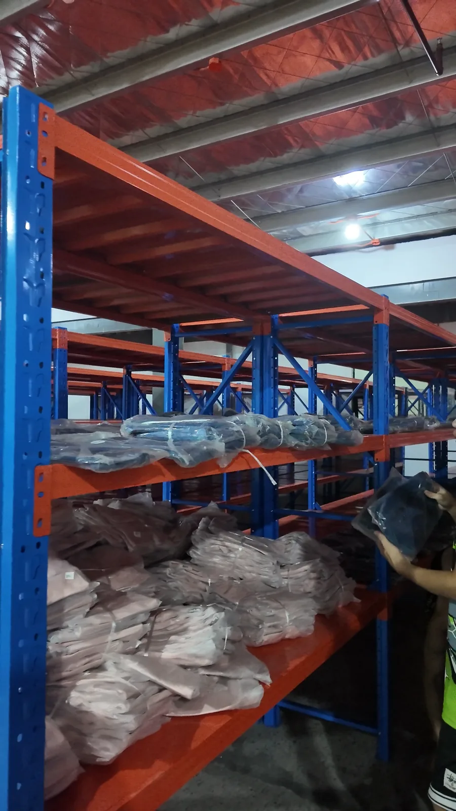 RunningBear Manila warehouse worker putting stock onto shelving
